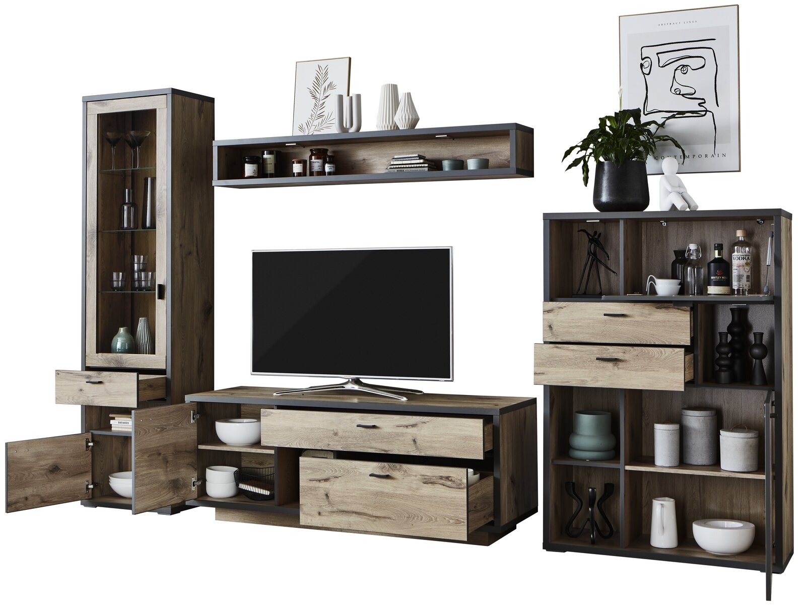Frontale Ansicht der Wandkombination Zurbrüggen ORLANDO mit Holzoptik, bestehend aus einem TV-Element, einem hohen Schrank mit Glastür und einem Regal mit Schubladen, dekoriert mit Geschirr und Pflanzen.