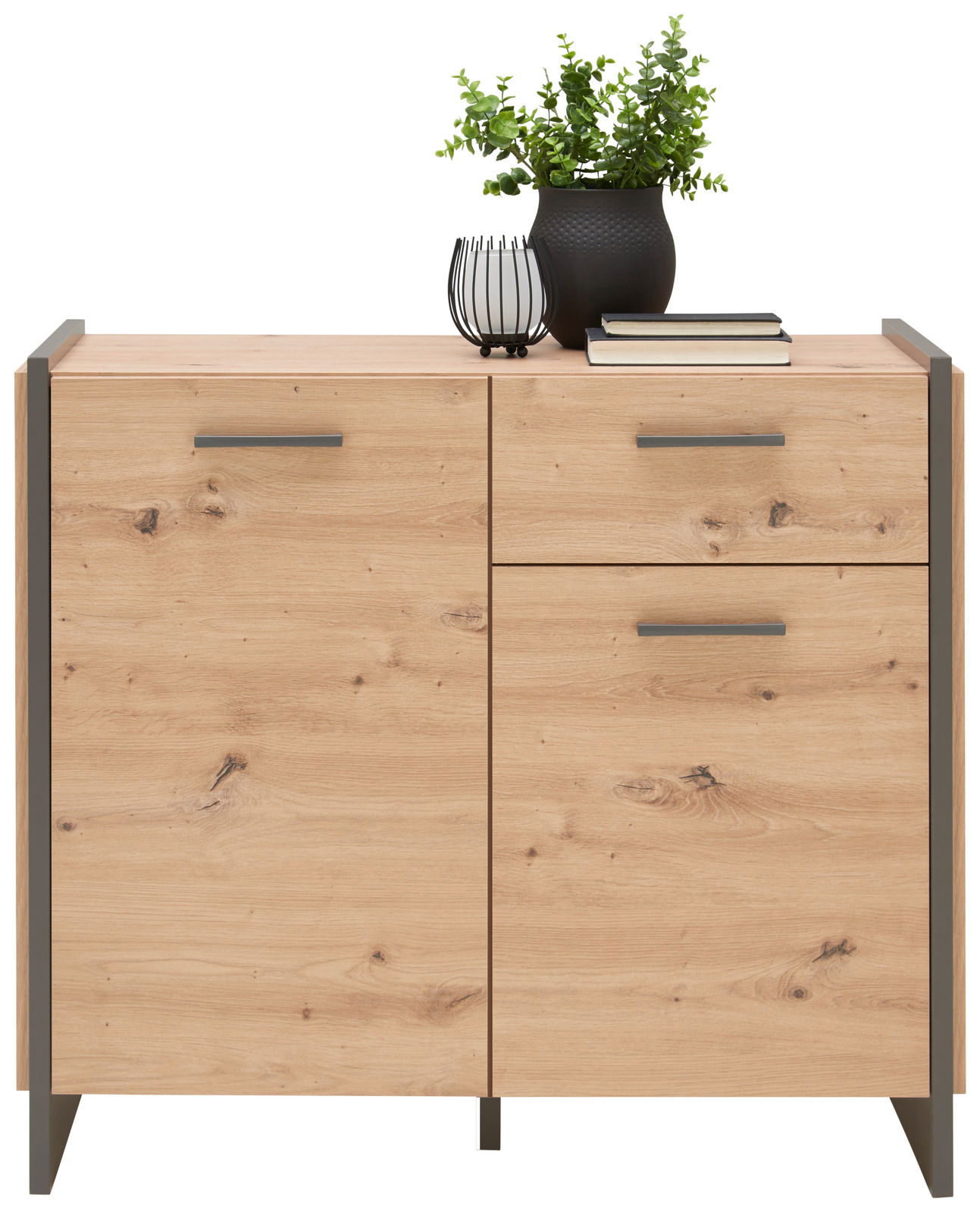 Holzkommode mit zwei Türen und einer Schublade, dekoriert mit einer Pflanze und Büchern, Frontalansicht