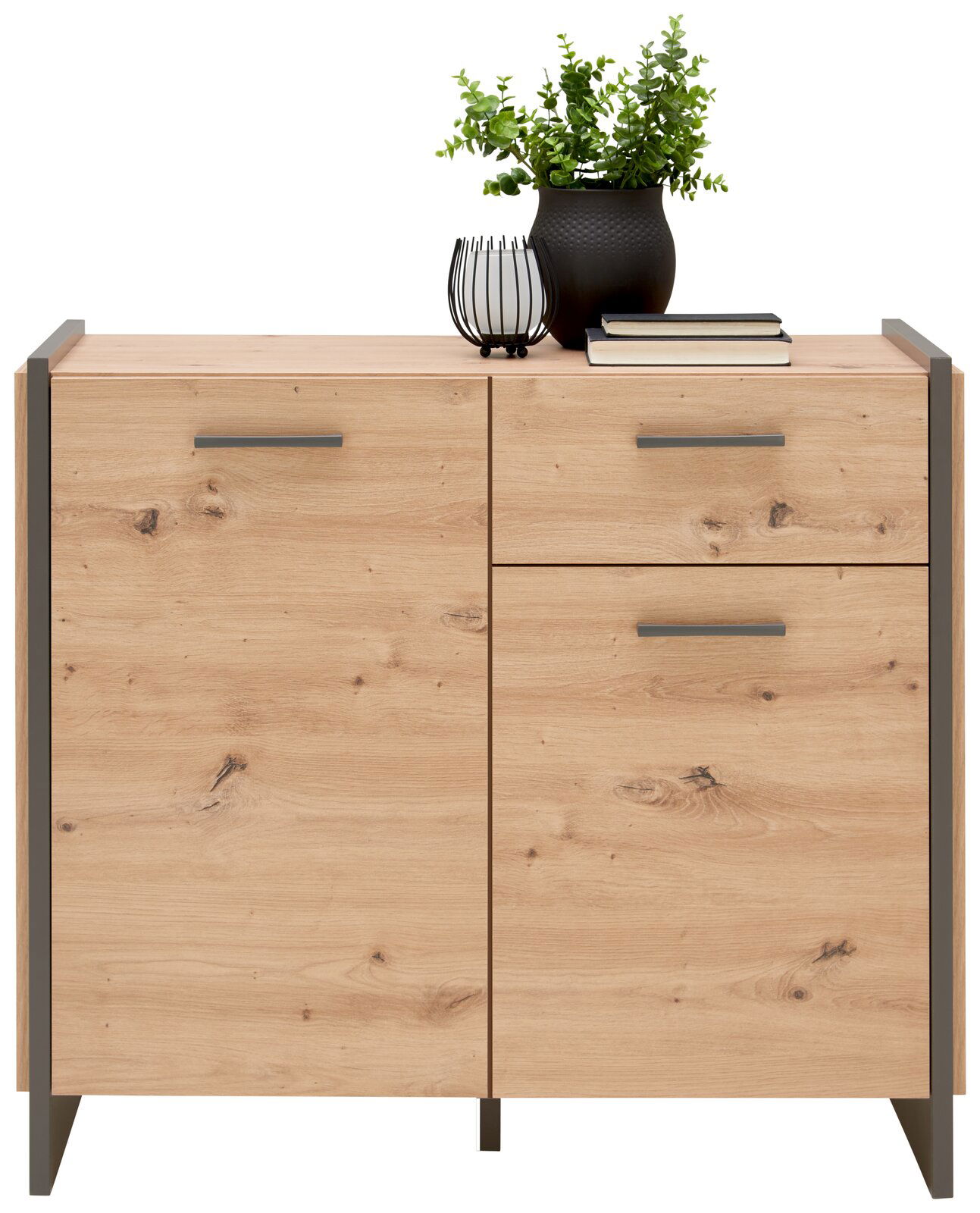 Holzkommode mit zwei Türen und einer Schublade, dekoriert mit einer Pflanze und Büchern, Frontalansicht