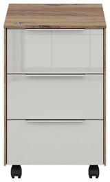Frontansicht eines Voleo Rollcontainers NEVADA mit drei Schubladen, Holzoptik-Oberfläche und weißen Fronten auf Rollen.