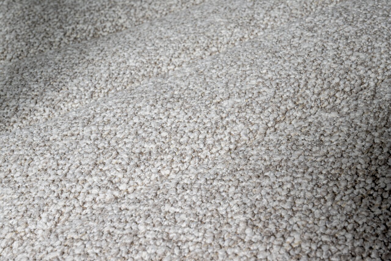 Nahaufnahme der strukturierten, grauen Stoffoberfläche eines Drehstuhlsitzes