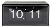 Schwarze Flip-Uhr mit weißer Anzeige, zeigt 10:11 AM, frontale Perspektive