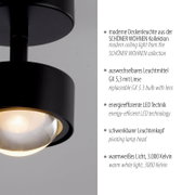 Moderne schwarze Deckenleuchte aus der SCHÖNER WOHNEN Kollektion mit schwenkbarem Leuchtenkopf und warmweißem Licht (3000 K), Nahaufnahme aus seitlicher Perspektive leicht von unten