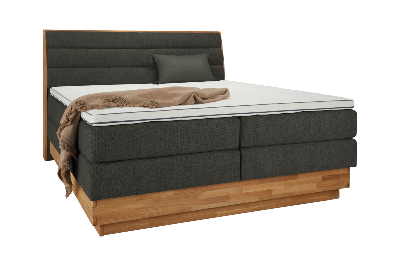 Boxspringbett mit dunkelgrauem Stoffbezug, Holzbasis und Kopfteil, seitliche Perspektive