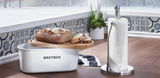 Brotbox mit Holzdeckel und frischem Brot, daneben ein moderner Küchenrollenhalter aus Metall, seitliche Perspektive