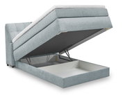 Boxspringbett Set One by Musterring Fairfield in seitlicher Perspektive mit geöffnetem Bettkasten.