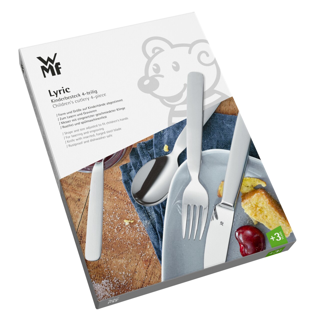 Lyric 4-delige kinderbestekset van WMF, bestaande uit een mes, vork, lepel en kleine lepel, op een verpakking met een bermotief, gefotografeerd vanuit een schuin perspectief.