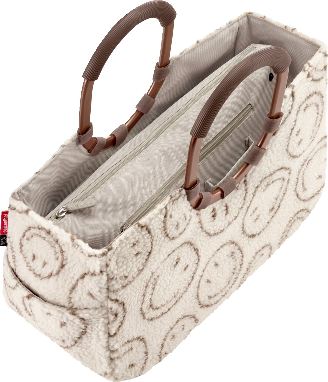 Beige Handtasche aus flauschigem Teddy-Material mit kreisförmigem Muster, braunen Tragegriffen und innenliegendem Reißverschlussfach, in schräger Draufsicht von oben vorn.