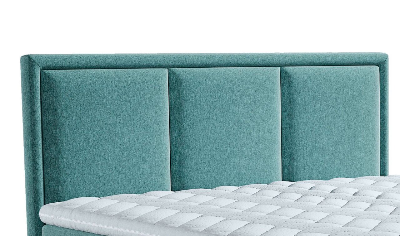Close-up van een turquoise boxspringbed met een gestoffeerd hoofdeinde en een zichtbaar deel van de matras.