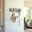 Umbra Wandgarderobe STICKS Moderne Wandgarderobe aus Holz mit geometrischem Design, frontal an einer weißen Ziegelwand montiert, mit aufgehängter Tasche und Leine.