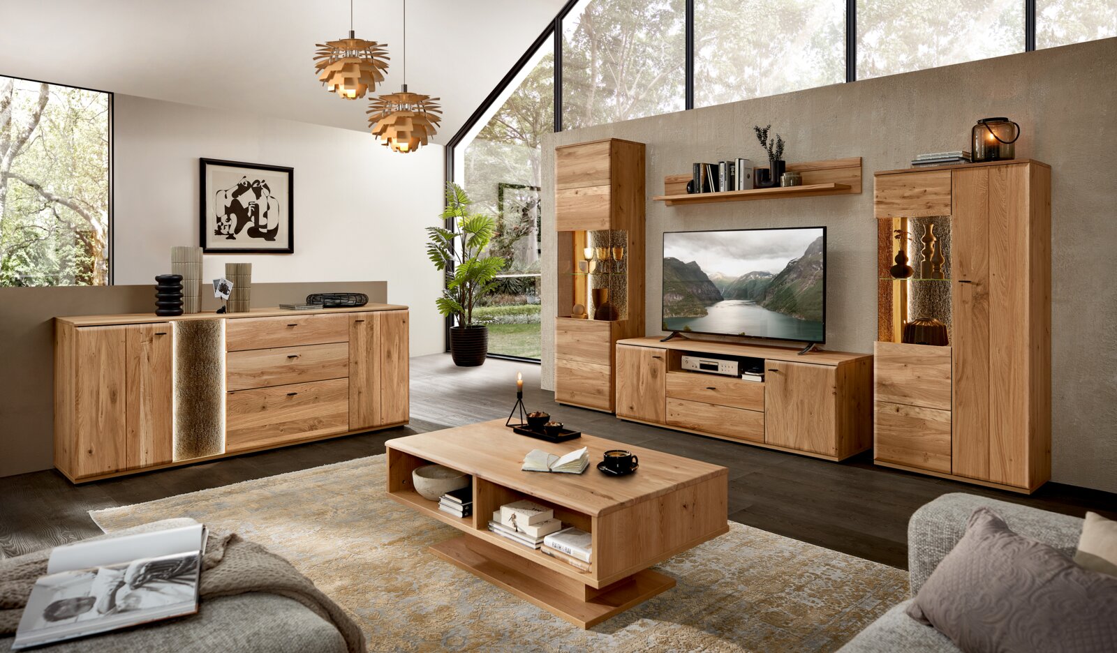 Cantus Sideboard REIMS Wohnzimmer-Set aus massivem Holz in natürlicher Optik mit TV-Lowboard, zwei Vitrinenschränken mit Beleuchtung, Wandboard, Sideboard und Couchtisch; Frontansicht in leicht schräger Perspektive