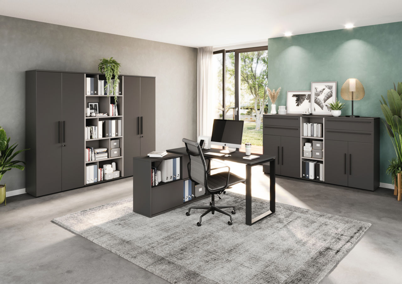 Moderne Büromöbel in einem hellen Raum mit großem Fenster, bestehend aus einem Winkelschreibtisch, mehreren Aktenschränken und Regalen. Perspektive von vorne links.