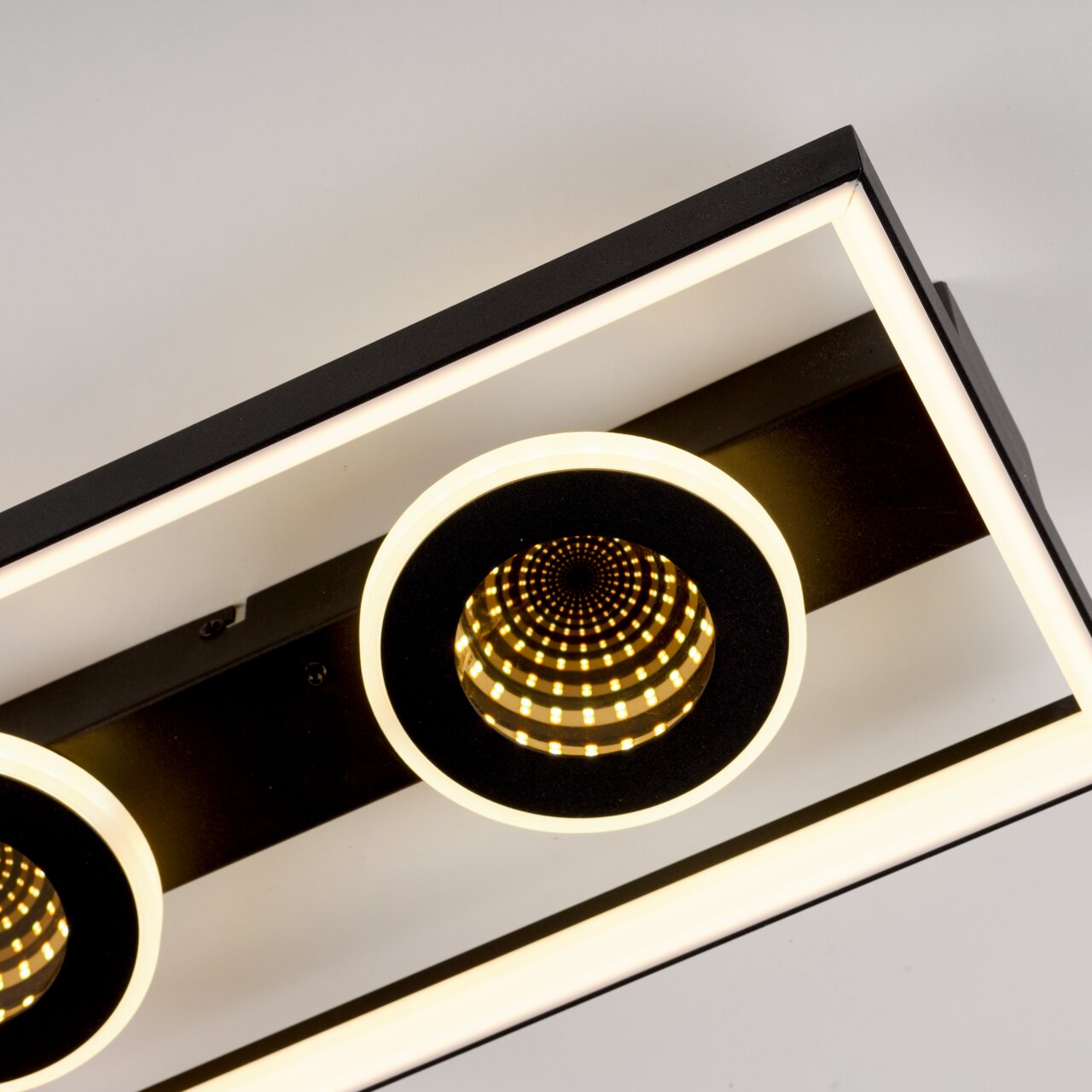 Moderne LED-Deckenleuchte mit geometrischem Design, aus der Seitenperspektive fotografiert.