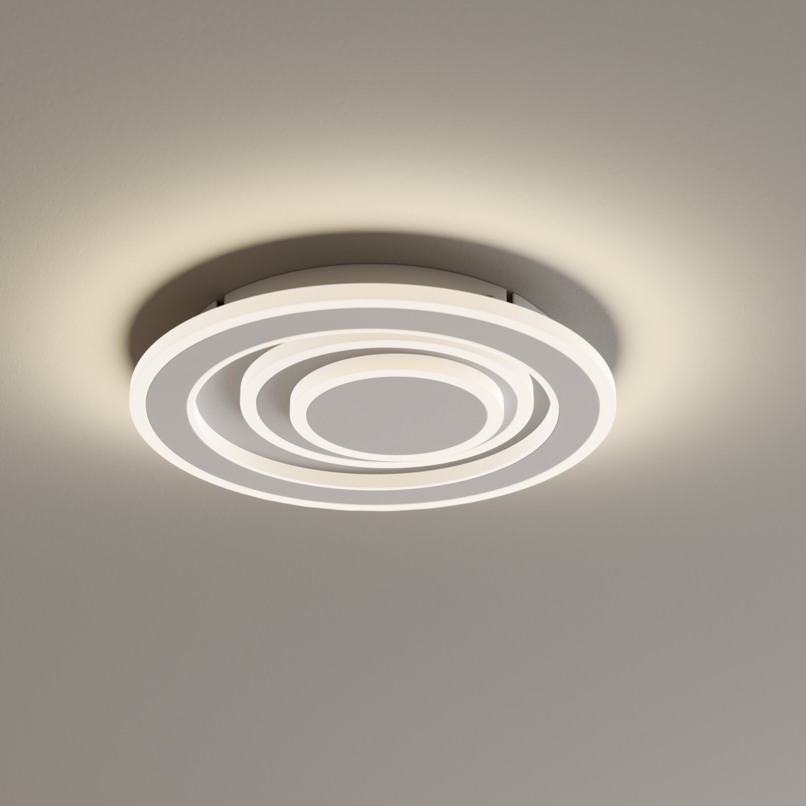 Novel LED-Deckenleuchte DECKENLEUCHTE Moderne runde LED-Deckenleuchte in Weiß mit konzentrischen Leuchtringen, warmweiß leuchtend, aus Untersicht an der Decke montiert