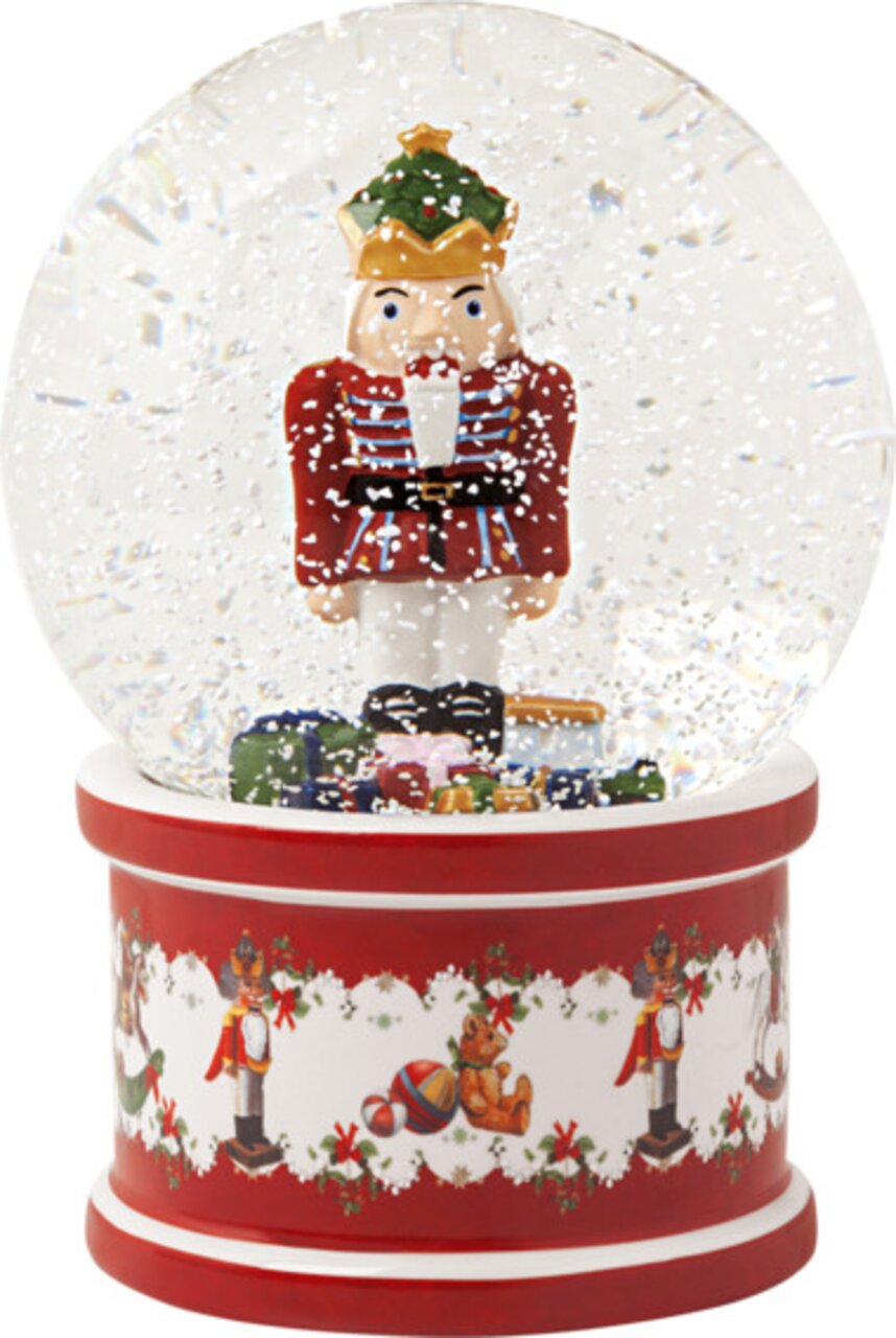Große Schneekugel mit Nussknacker, frontal abgebildet, auf rotem Sockel mit weihnachtlichen Motiven.