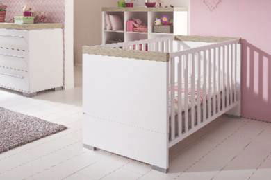 Weißes Babybett in einem Babyzimmer, seitliche Perspektive