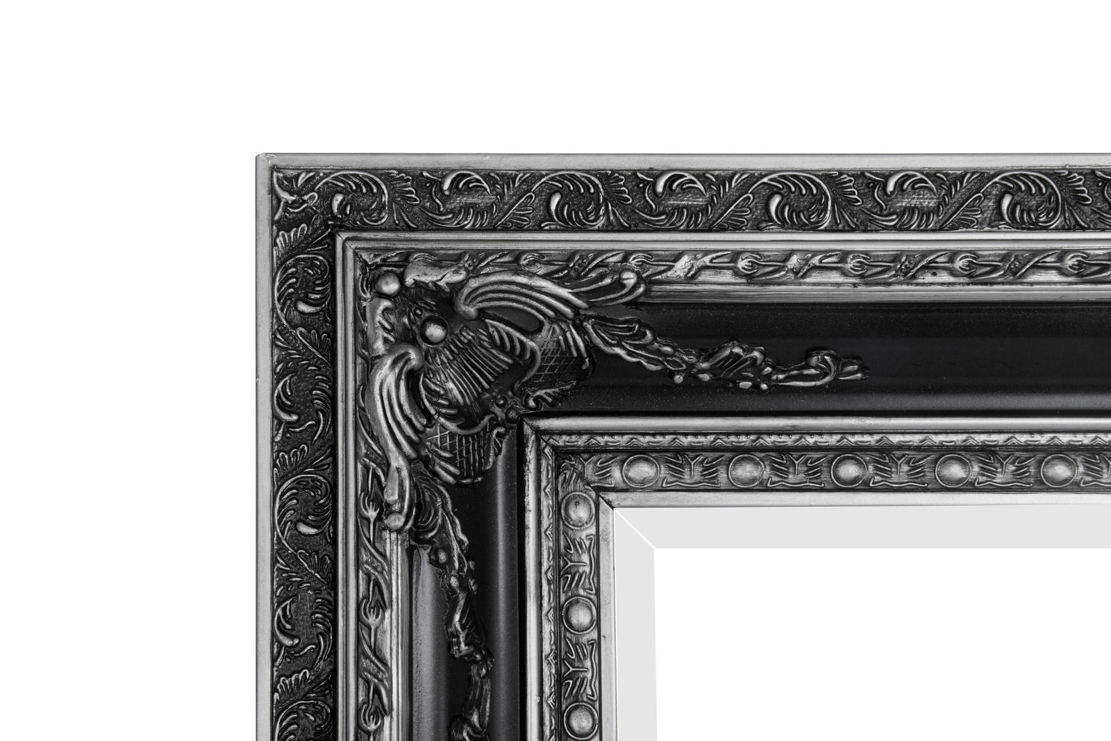 Detailansicht eines kunstvoll verzierten schwarzen Spiegelrahmens mit floralen Mustern.