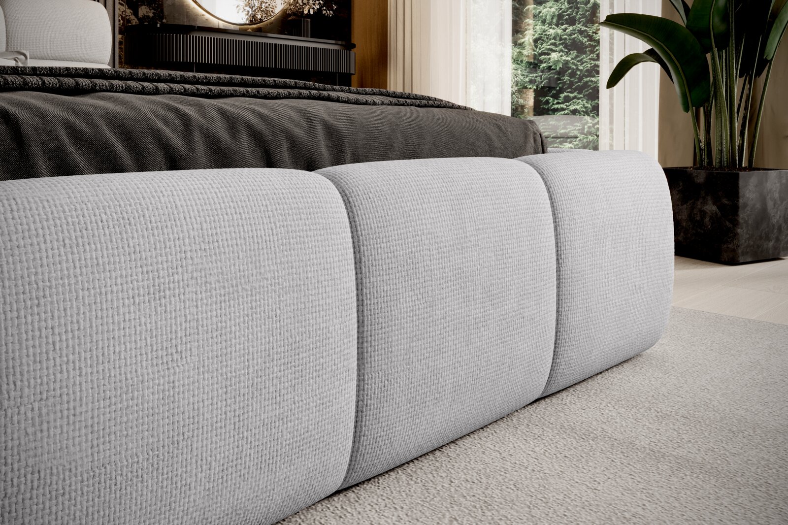 Nahaufnahme eines modernen Polsterbetts mit grauem Stoffbezug, seitliche Perspektive.