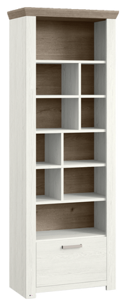 Weißes Regal mit mehreren Fächern und einer Schublade, aus einer leicht seitlichen Perspektive fotografiert.