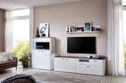 Moderne weiße Wandkombination mit TV-Schrank, Regal und Vitrine in einem hellen Wohnzimmer, seitliche Perspektive.
