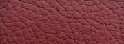 Nahaufnahme der strukturierten, roten Lederoberfläche eines Sessels