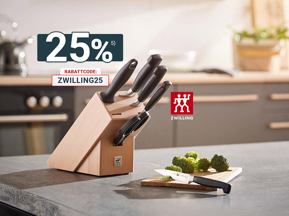 Zwilling Messerblock mit Küchenmessern auf Arbeitsplatte, daneben Schneidebrett mit Brokkoli.