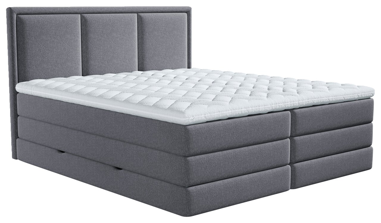 Graues gepolstertes Boxspringbett mit hohem, dreigeteiltem Kopfteil und weißem gestepptem Topper, aus schräger Vorderansicht