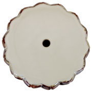 Runde, wellenförmige Schale/Platte in Cremeweiß mit braunem Rand und kleinem Loch in der Mitte, Draufsicht (Top-Down) auf weißem Hintergrund