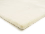 Weißer Fellteppich in Nahaufnahme, perspektivisch von der Seite fotografiert