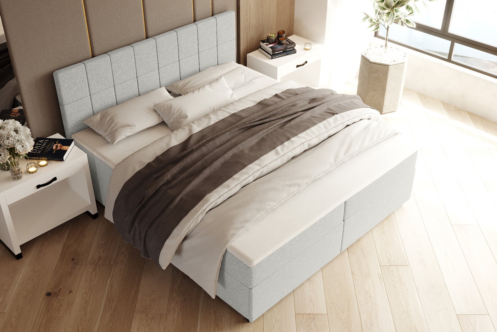 Hellgraues Boxspringbett mit gepolstertem, kariert abgestepptem Kopfteil und weiß-grauer Bettwäsche im modernen Schlafzimmer, schräg von oben aus der Ecke fotografiert