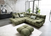 Groene hoekbank in een moderne woonkamer met een industrieel design, gefotografeerd vanuit een iets hoger standpunt.
