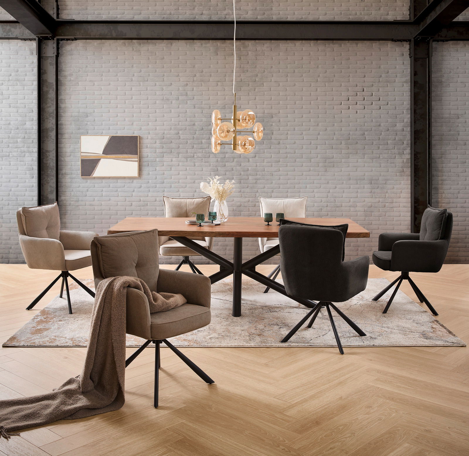 Moderner Esstisch mit Holzplatte und schwarzem Metallgestell, umgeben von gepolsterten Stühlen in einem stilvollen Esszimmer mit Ziegelwand und hängender Designerlampe. Perspektive: Frontalansicht.