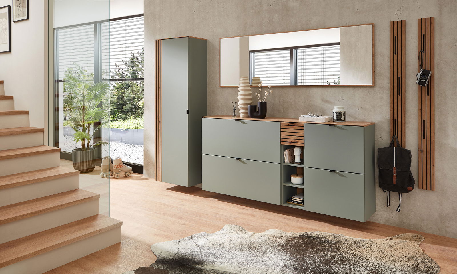 Moderner Eingangsbereich mit grünem Garderoben-Hängeschrank und Spiegel, seitliche Perspektive