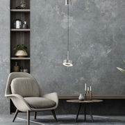 Moderne Pendelleuchte Q-ROTATE in einem stilvollen Wohnzimmer, seitliche Perspektive.