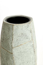 Moderner, geometrisch geformter Topf aus grauem Material, Ansicht von schräg oben.