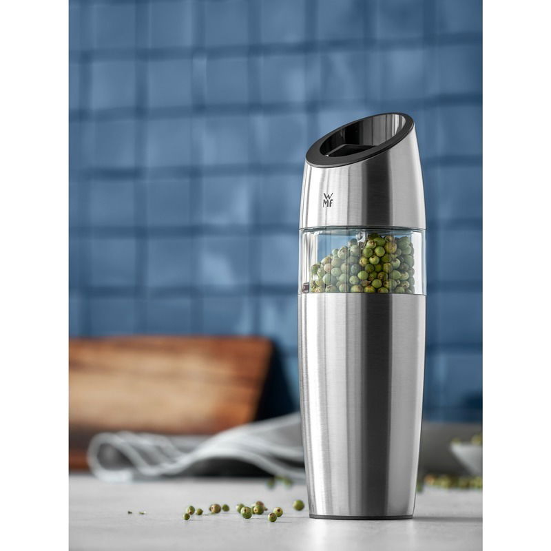 Elektrische Mühle aus Edelstahl mit transparentem Behälter, gefüllt mit grünen Pfefferkörnern, seitliche Perspektive