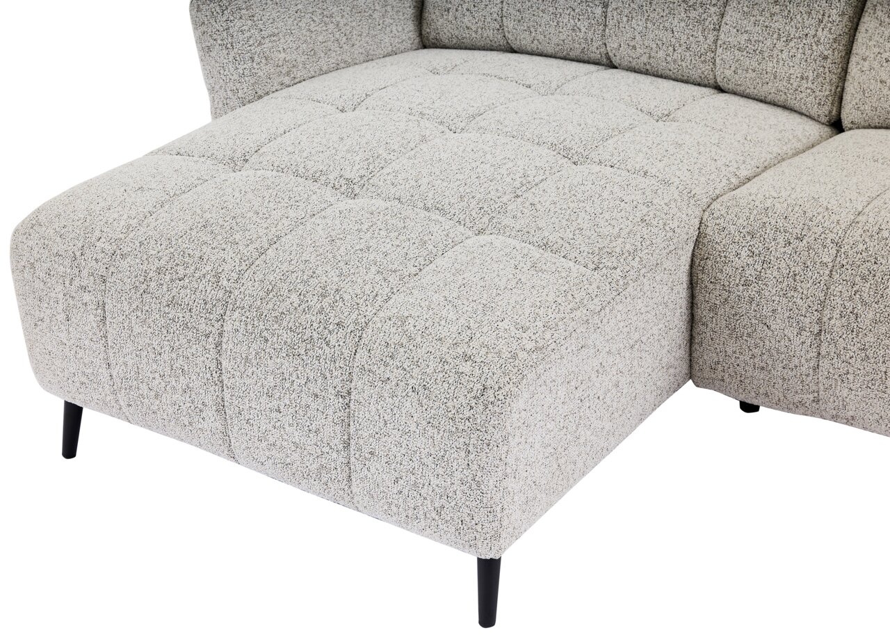 Nahaufnahme einer hellgrauen, strukturierten Ecksofa-Rundecke mit schwarzen Beinen, von schräg oben fotografiert.