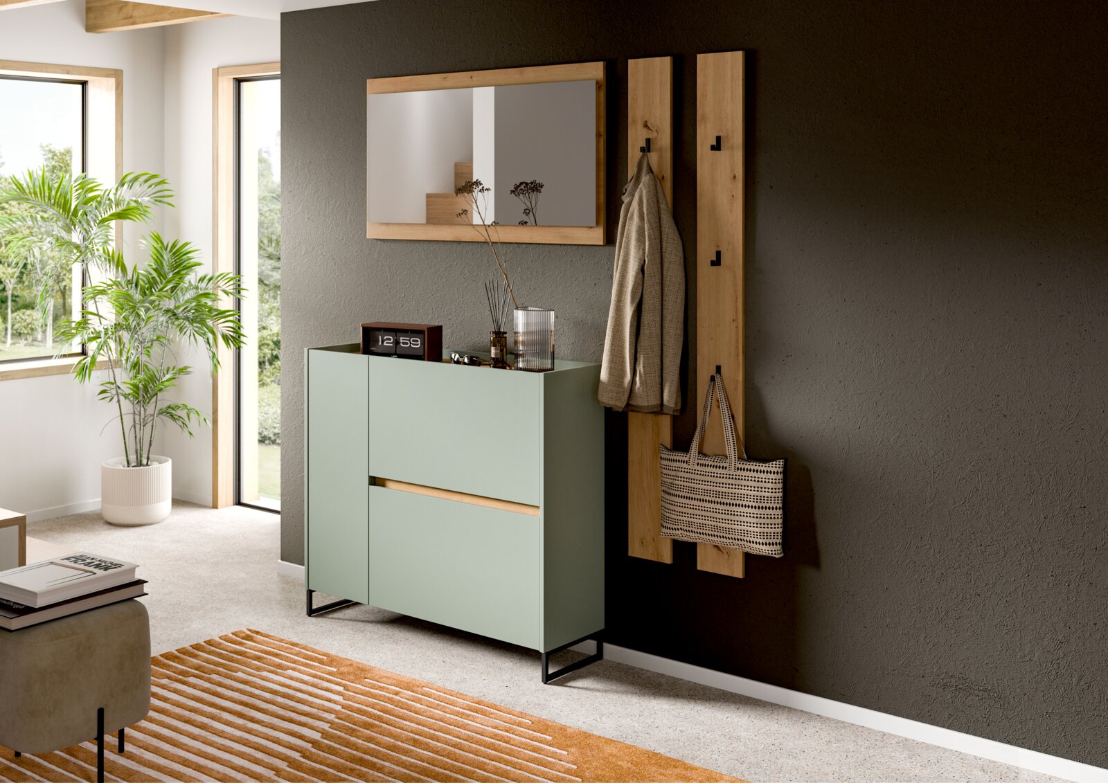 Modernes Flur-Set mit mintgrünem Sideboard auf schwarzem Metallgestell, Holz-Wandspiegel und Garderobenpaneelen mit Haken an grauer Wand, fotografiert in leichter Schrägansicht von vorn rechts.