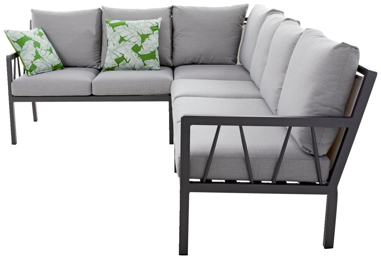 Lounge-Set in L-Form mit grauen Kissen und grünen Zierkissen mit Blattmuster, seitliche Perspektive