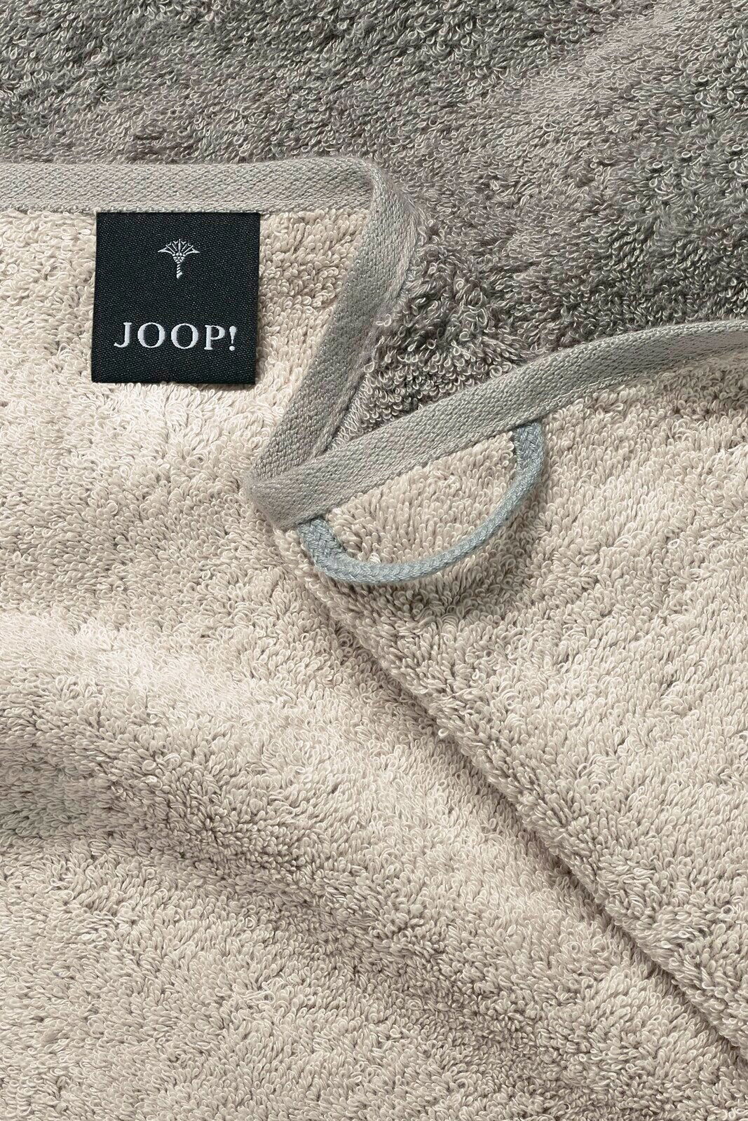 JOOP! Handtuch DOUBLEFACE CLASSIC Nahaufnahme eines beigen Handtuchs mit grauem Rand und einem schwarzen Etikett mit der Aufschrift 'JOOP!'