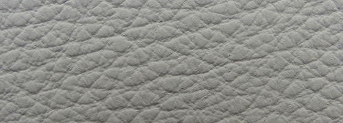 Bacher Sessel KAMA Nahaufnahme einer grauen, strukturierten Lederoberfläche, verwendet für einen Sessel.