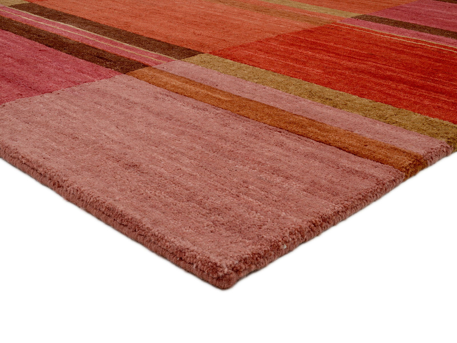 Wollteppich in warmen Rottönen mit geometrischem Muster, perspektivisch von der Ecke aufgenommen
