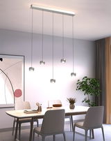 Moderne LED-Pendelleuchte mit fünf hängenden Leuchten über einem Esstisch, seitliche Perspektive