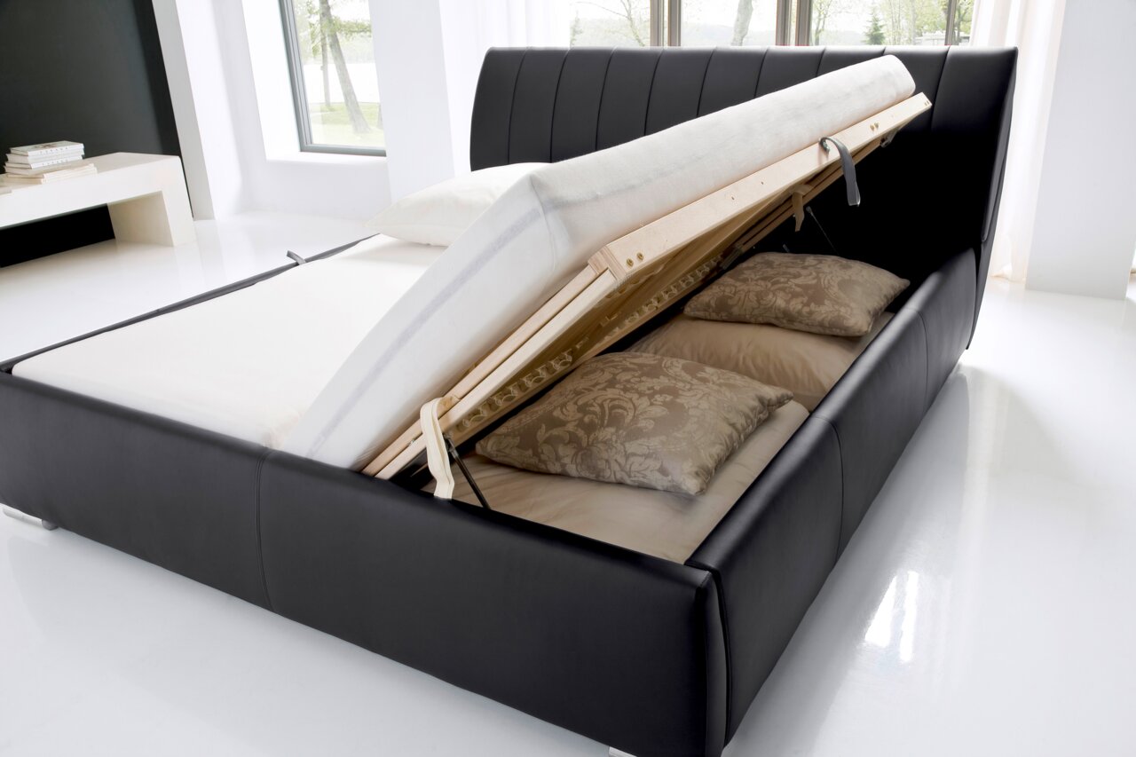 Polsterbett mit hochgeklappter Matratze und Stauraum, seitliche Perspektive