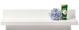 Weißes Wandregal mit einer blauen Blume und einer Tube Kamille-Creme, frontale Ansicht
