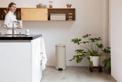 Beige pedaalemmer in een moderne keuken, zijaanzicht