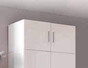 Weißer, glänzender Schrankaufsatz mit zwei Türen und silbernen Griffen, seitliche Perspektive.