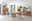 Moderne Wohnzimmermöbel aus Holz mit LED-Beleuchtung, bestehend aus Vitrinen, Sideboard und Esstisch mit grauen Stühlen, aus der Perspektive des Raumes fotografiert.