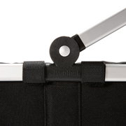 Nahaufnahme des schwarzen Carrybag xs mit Fokus auf den Griffmechanismus.