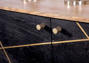 Nahaufnahme eines modernen Sideboards mit dunkler Steinoptik, goldenen Griffen und dekorativen goldenen Linien, von vorne betrachtet.